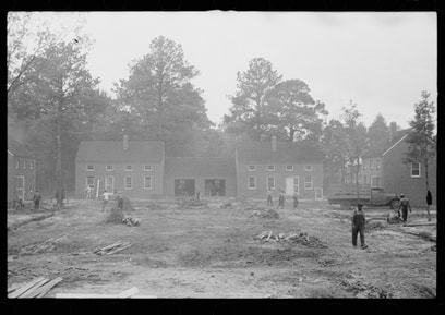 Black and white image of a house under construction.